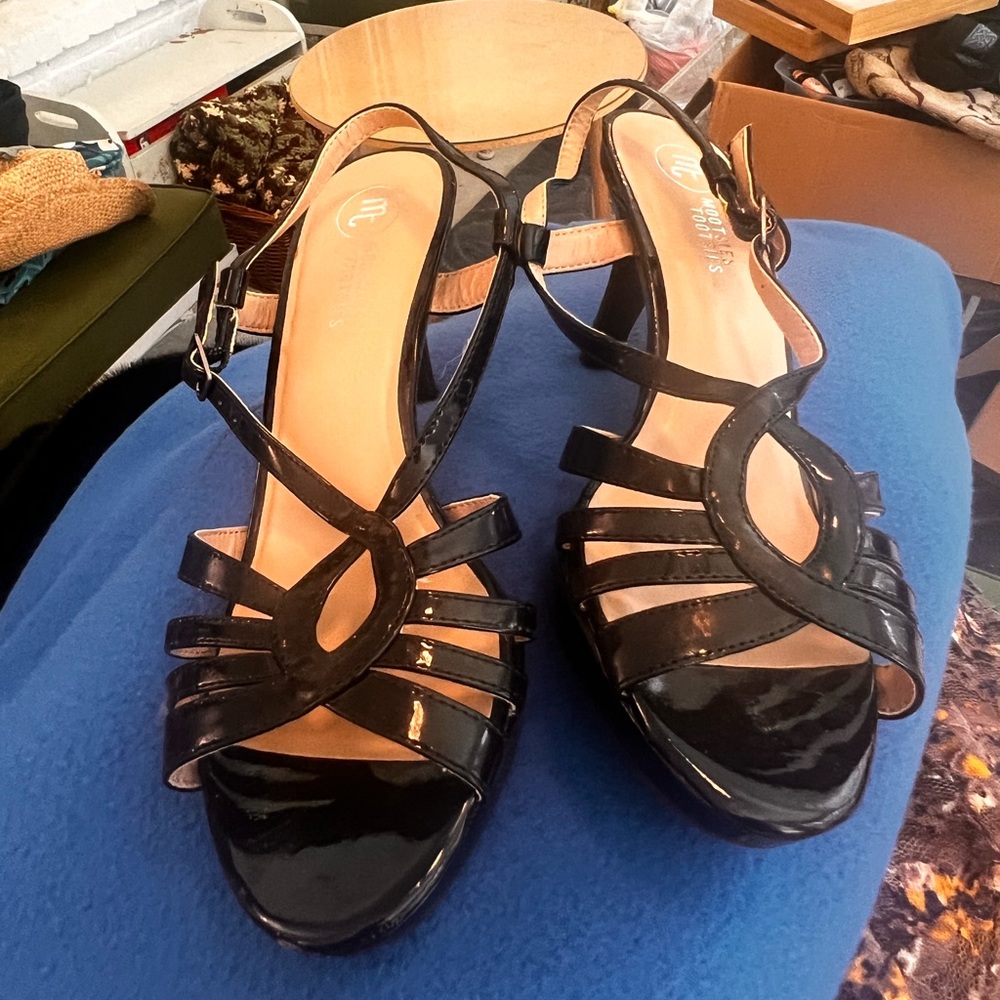 20% off listed price. Sling back strapped black vinyl dress heels